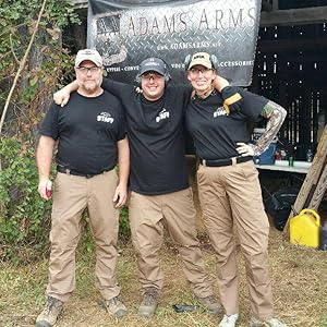 three people posing for the camera